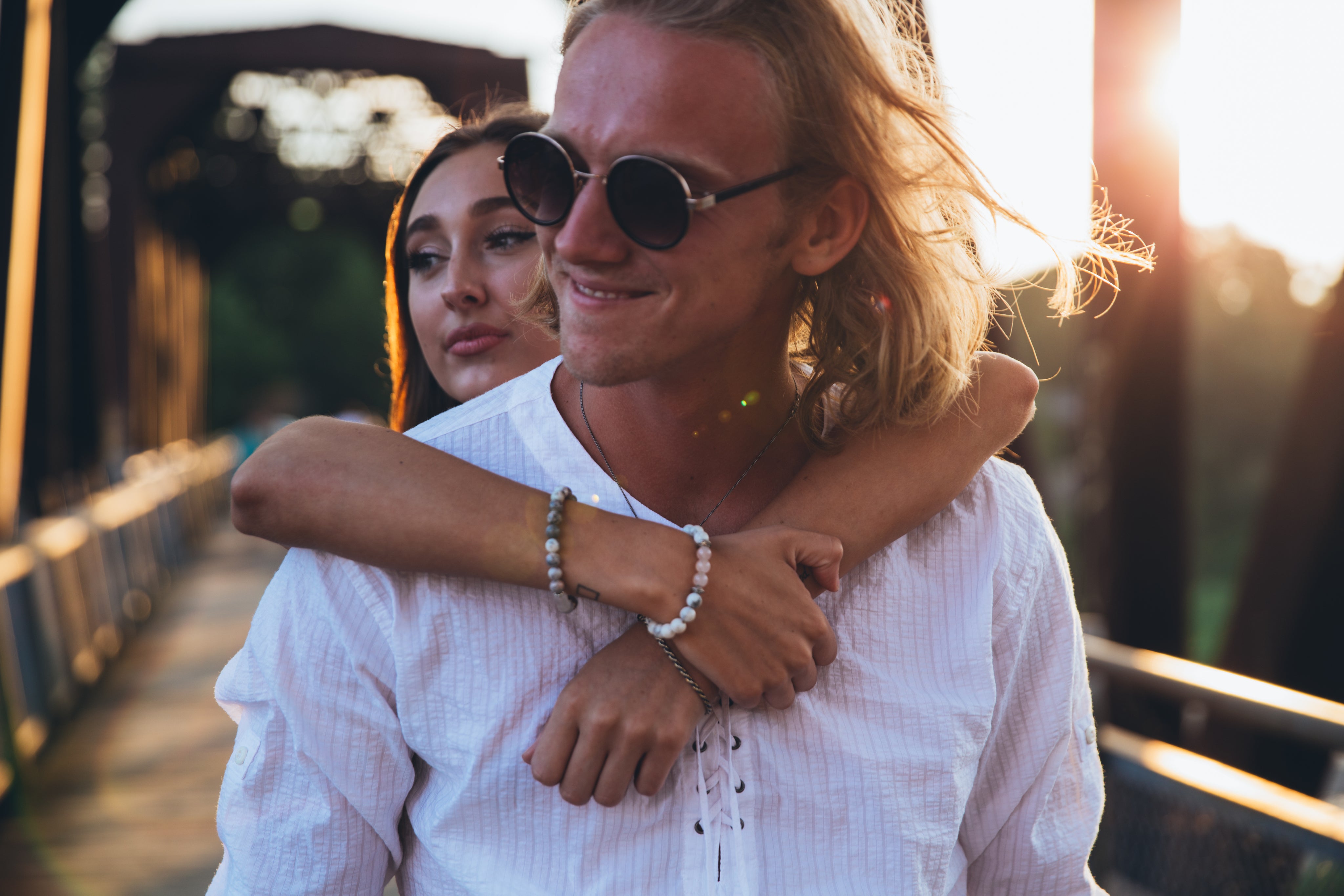 Couple silhouetted against a vibrant sunset, embracing. Shop men's and women's clothing up to 80% off.
